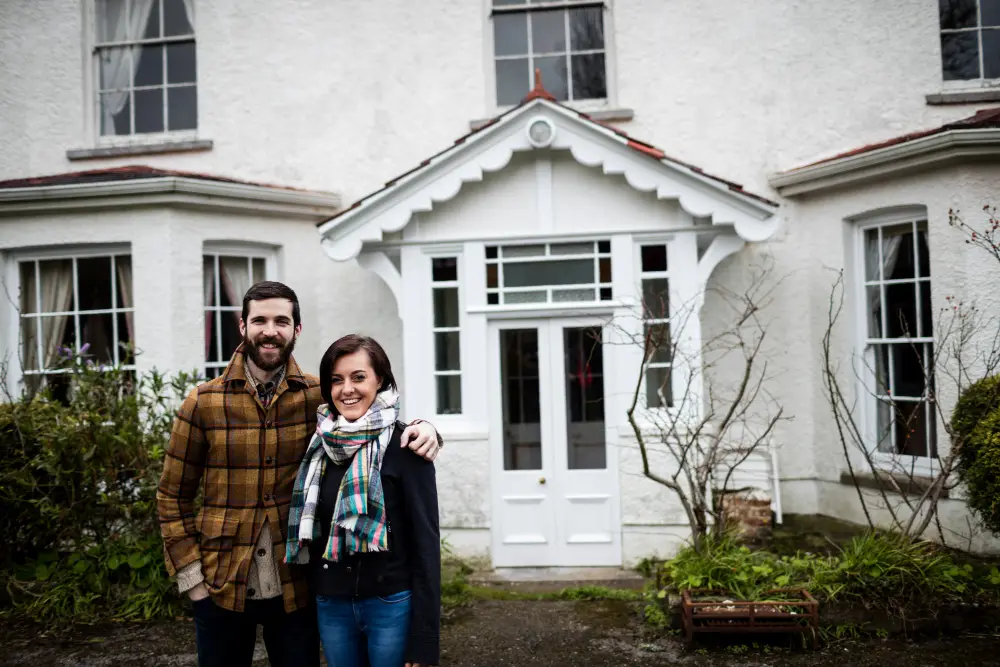 happy couple stnading outside house