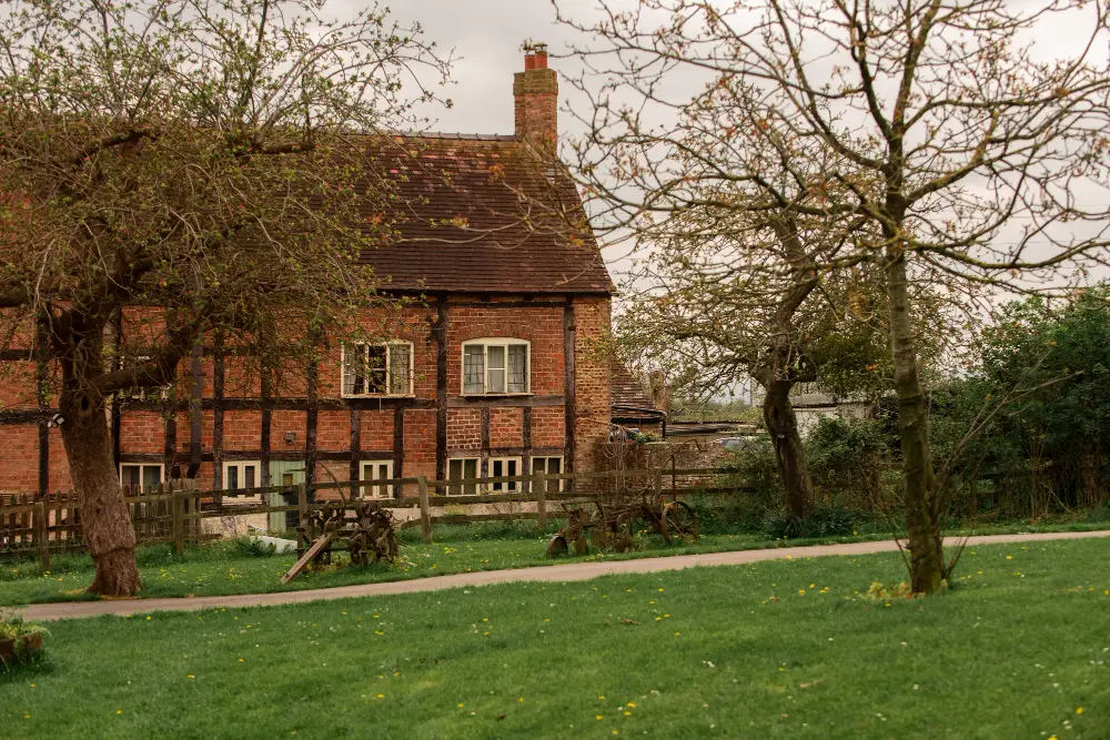 Timber-framed brick house with a garden