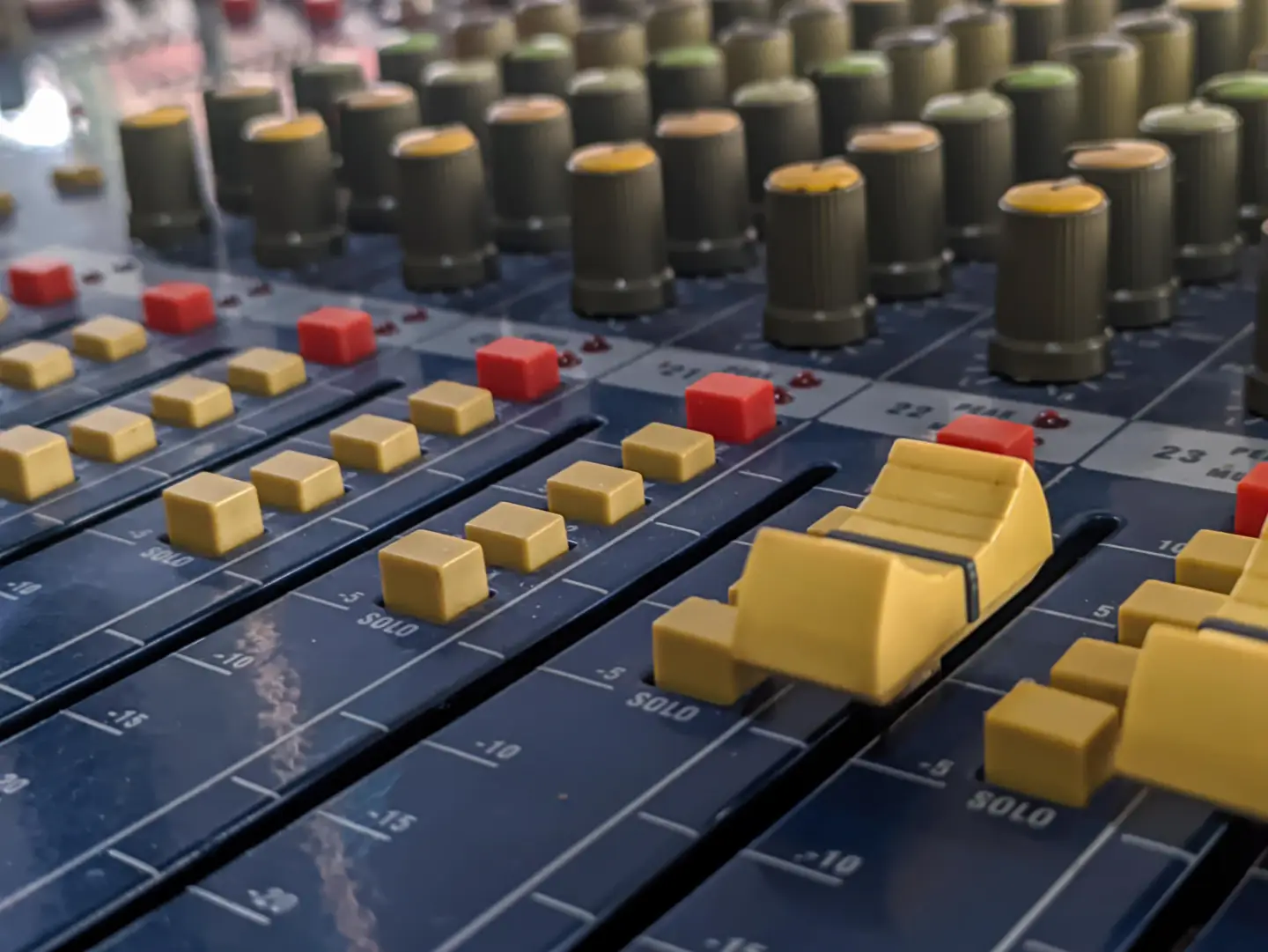 Close-up of a professional audio mixing desk