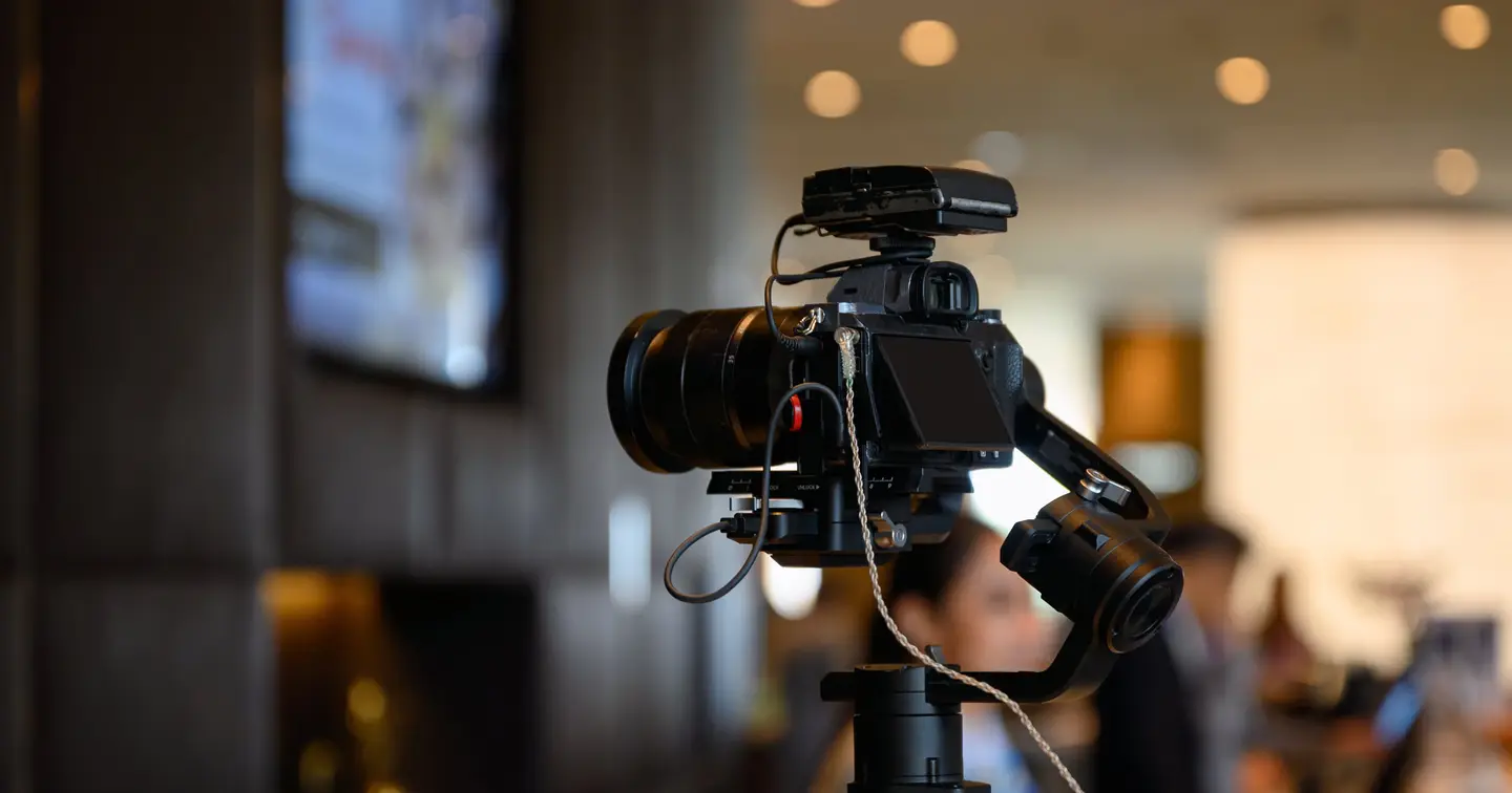 Camera on a tripod in a softly lit room