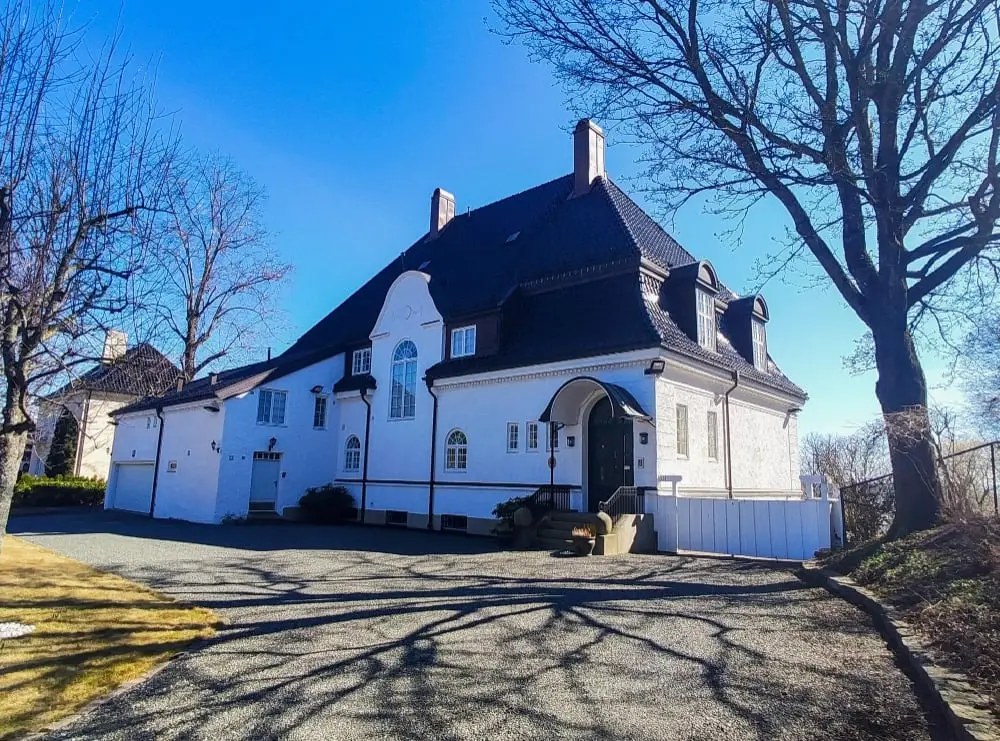 White house with a slate roof on a sunny winter day