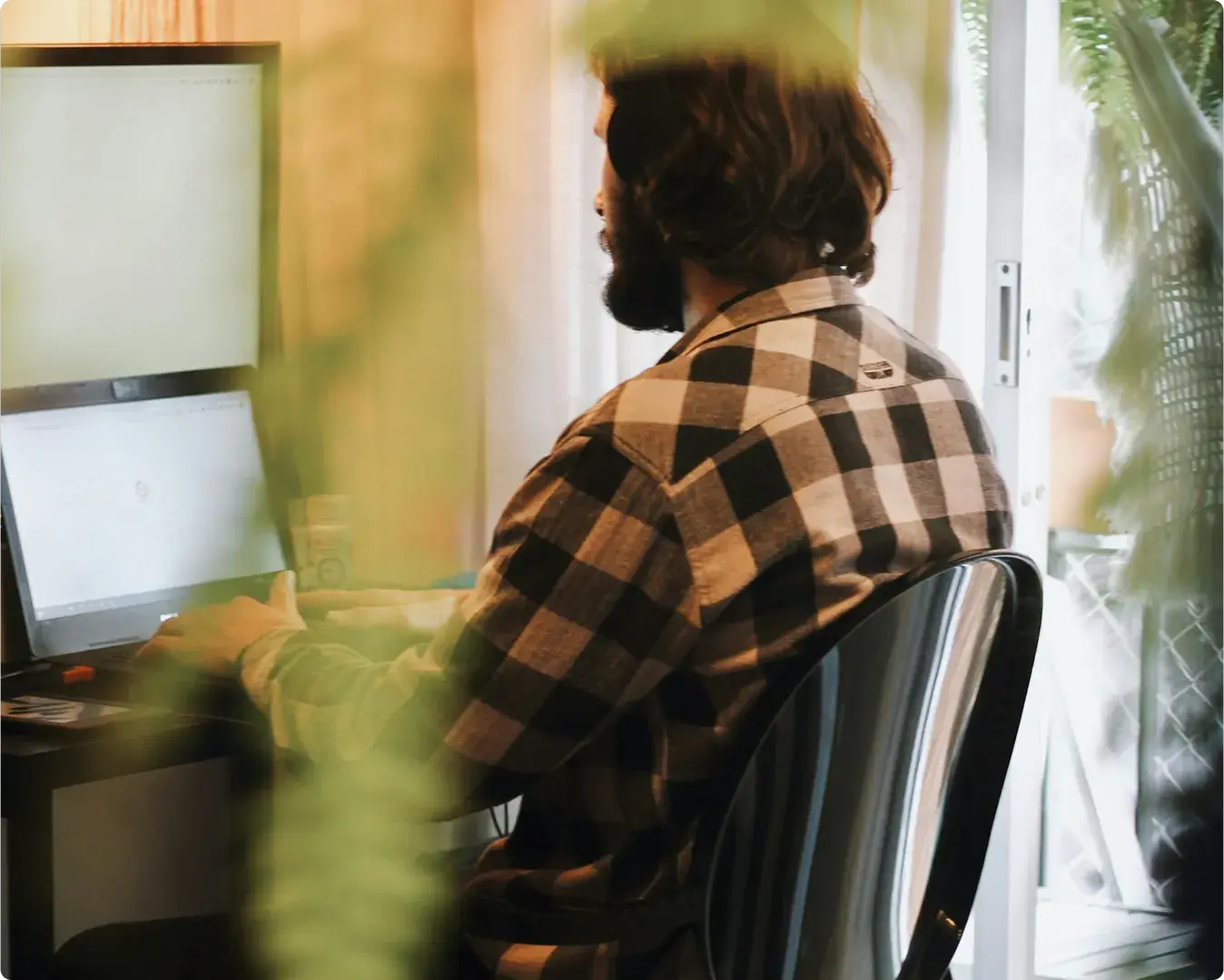 Man working at a computer at home
