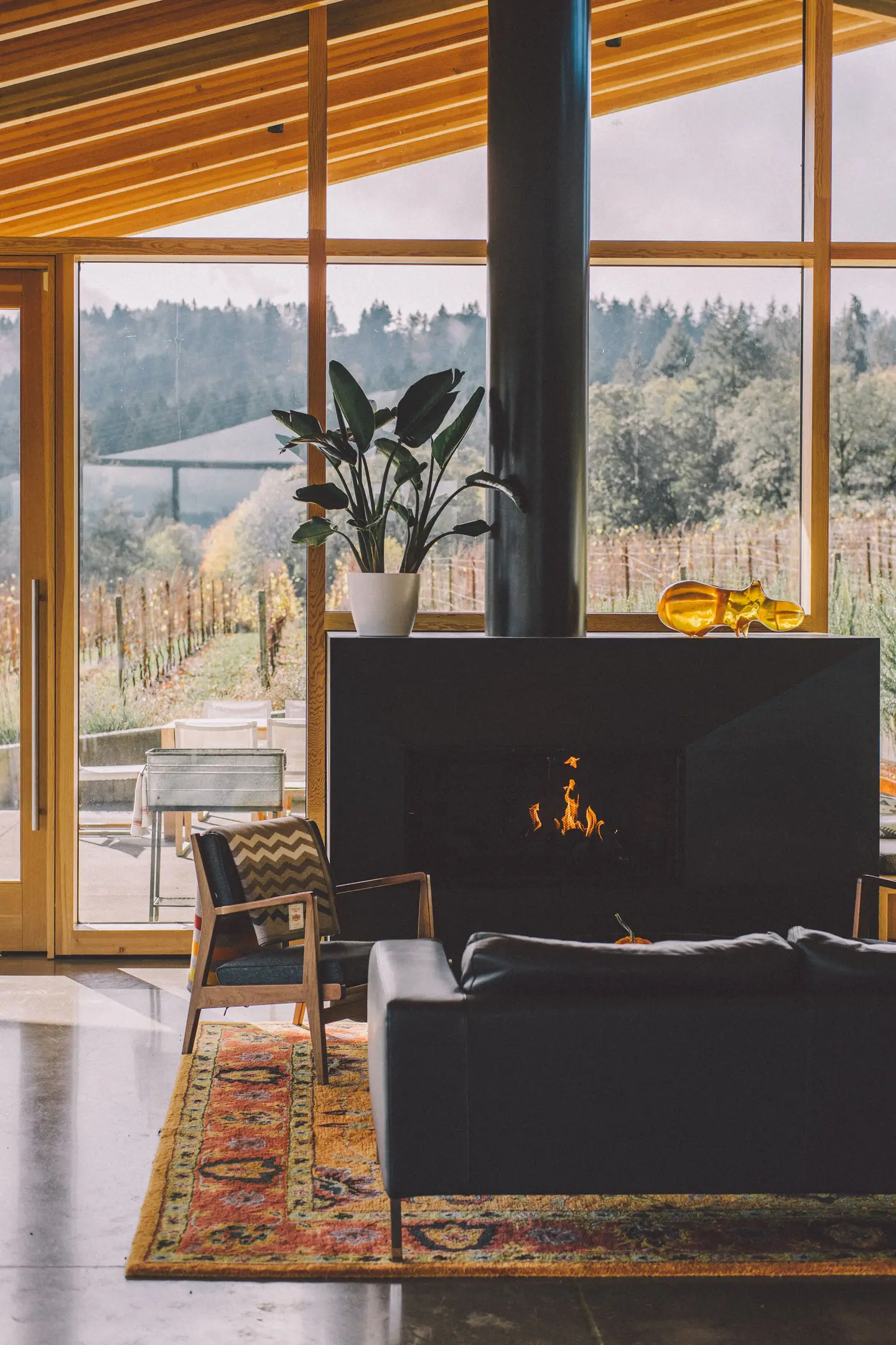 Living room with a wood-burning stove and garden views