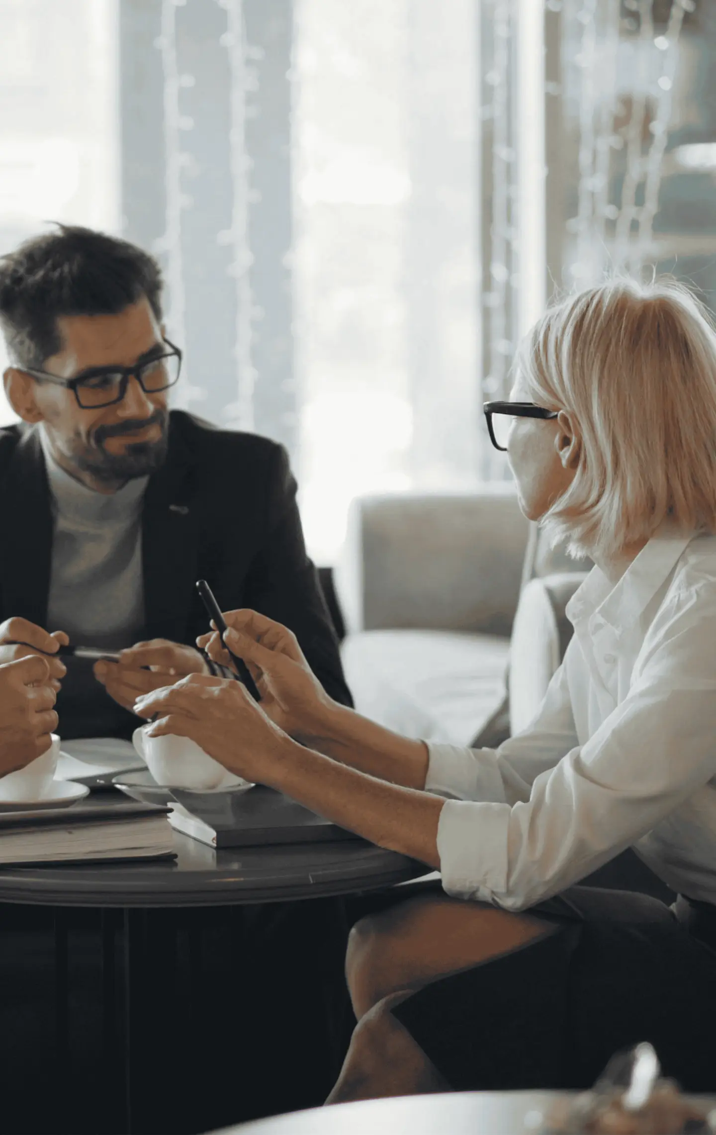 Two people talking over a table at home